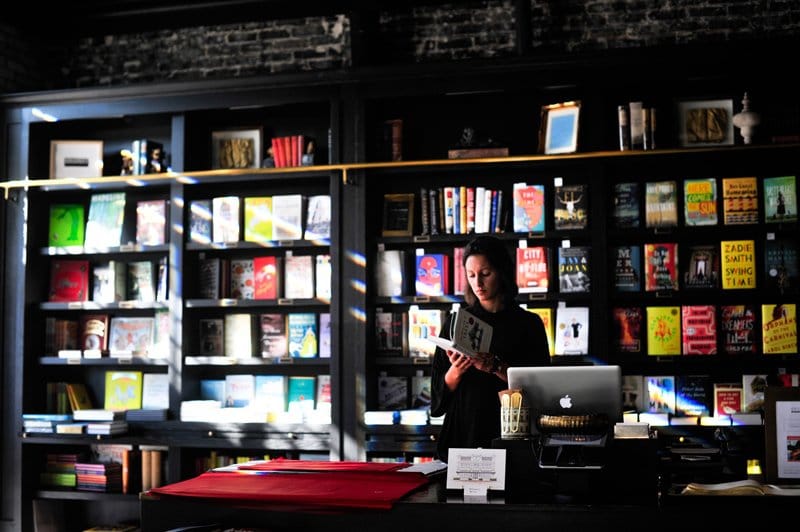 a person standing in front of a book store