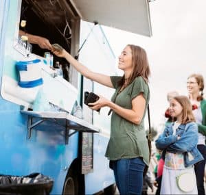 a person serving food from a food truck