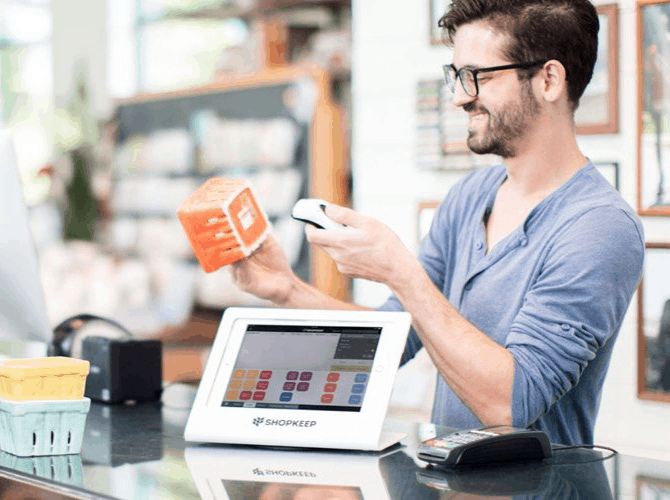 a person holding a box and a device 