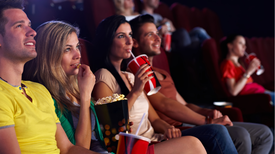 People in a cinema watching a movie with refreshments