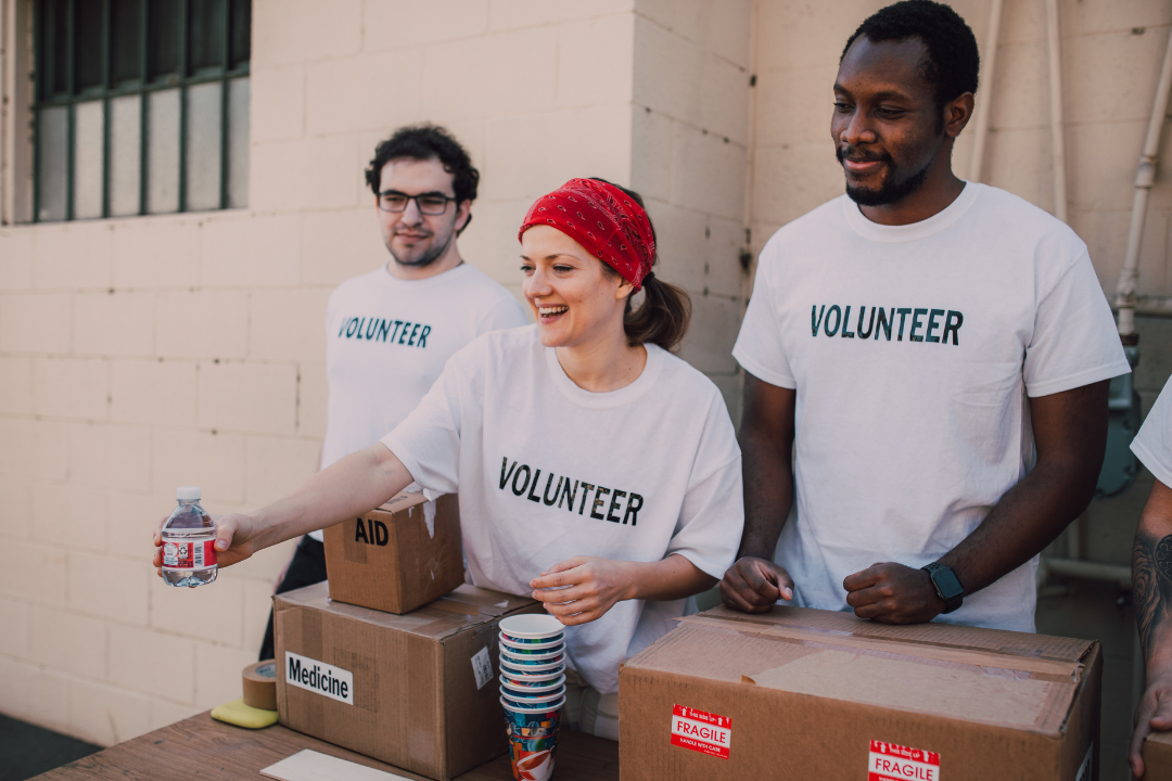 Nonprofit Volunteers Passing Out Canned Food